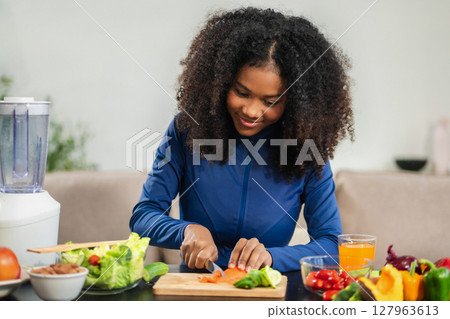Fit woman enjoys healthy fruit breakfast after yoga training. fitness, nutrition, home lifestyle. 127963613