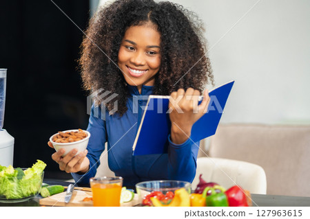Fit woman enjoys healthy fruit breakfast after yoga training. fitness, nutrition, home lifestyle. Fit woman enjoys healthy fruit breakfast after yoga training. fitness, nutrition, home lifestyle. 127963615