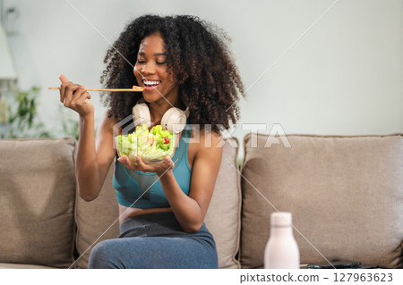 Fit woman enjoys healthy fruit breakfast after yoga training. fitness, nutrition, home lifestyle. Fit woman enjoys healthy fruit breakfast after yoga training. fitness, nutrition, home lifestyle. 127963623