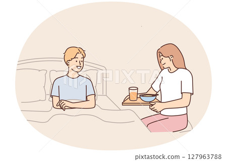 Caring wife brings breakfast to bed to beloved husband wanting to bring joy or caring during illness Caring wife brings breakfast to bed to beloved husband wanting to bring joy or caring during illness 127963788