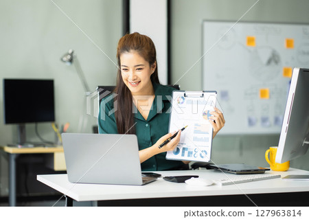 Asian businesswoman teleconference, idea presentation, planning analysis and financial statistics and investment market at office. 127963814