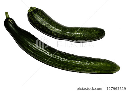 Close up of home grown cucumber courgette zucchini baby marrow vegetable skin green on white background Close up of home grown cucumber courgette zucchini baby marrow vegetable skin green on white background 127963819