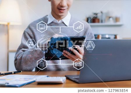 Male using mobile phone play social media and enjoying coffee sitting in the kitchen. 127963854