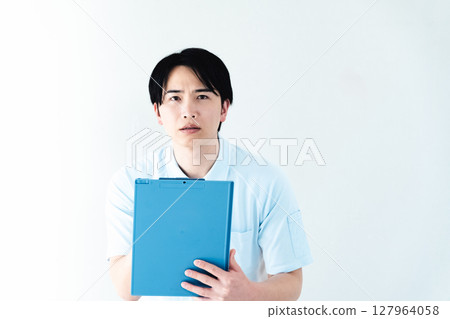 A man working as a caregiver holding a file 127964058