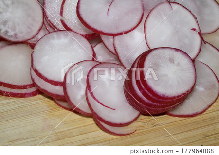 Chopped Up Sliced Radish on a Chopping Board in a Kitchen Chopped Up Sliced Radish on a Chopping Board in a Kitchen 127964088