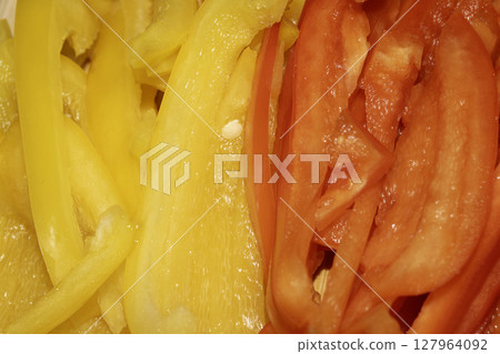 Close up of red pepper and carrot finely cut vegetable slices for cooking 127964092