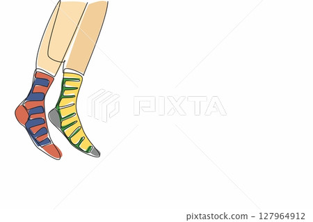 Single continuous line drawing a pair of feet wearing socks with different stripes on the right and left. Walk freely with confidence. Freedom. Anti Bullying Day. One line design vector illustration 127964912