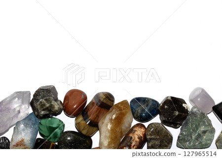 Collection of holistic healing crystal pieces and rocks spiritual on a white background tigers eye and garnet Collection of holistic healing crystal pieces and rocks spiritual on a white background tigers eye and garnet 127965514