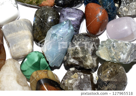 Collection of holistic healing crystal pieces and rocks spiritual on a white background tigers eye and garnet 127965518