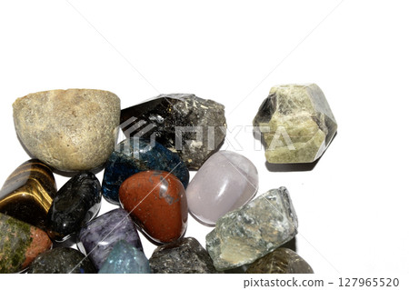 Collection of holistic healing crystal pieces and rocks spiritual on a white background tigers eye and garnet Collection of holistic healing crystal pieces and rocks spiritual on a white background tigers eye and garnet 127965520