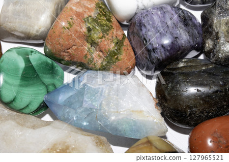 Collection of holistic healing crystal pieces and rocks spiritual on a white background tigers eye and garnet 127965521