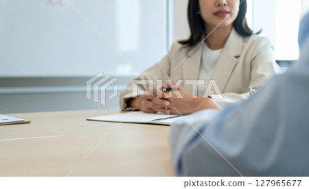 Business person holding a pen and listening 127965677