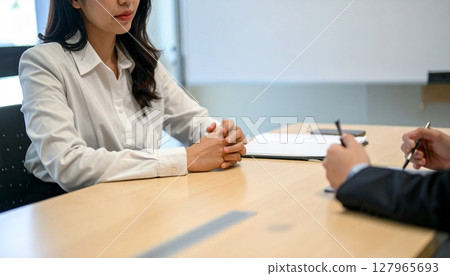 Business person holding a pen and listening 127965693