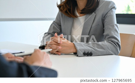 Business person holding a pen and listening 127965695