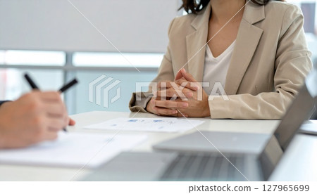 Business person holding a pen and listening 127965699