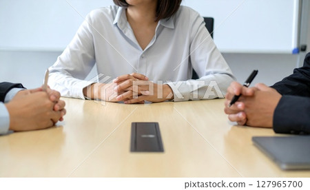 Business person holding a pen and listening 127965700