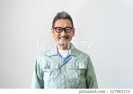 Senior man in work clothes, looking at camera, portrait 127965723