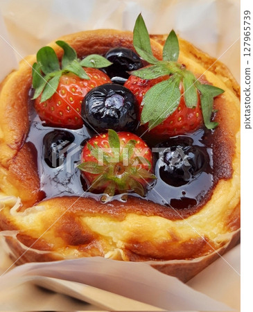 Rich and creamy burnt cheesecake with a perfectly caramelized top, crowned with fresh fruits for a delightful burst of flavor and texture in every bite. Rich and creamy burnt cheesecake with a perfectly caramelized top, crowned with fresh fruits for a delightful burst of flavor and texture in every bite. 127965739