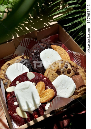 Freshly baked cookies with a golden-brown finish and chocolate chips. Perfectly crisp on the edges with a soft center, offering a delicious, comforting treat for any occasion. Freshly baked cookies with a golden-brown finish and chocolate chips. Perfectly crisp on the edges with a soft center, offering a delicious, comforting treat for any occasion. 127965741