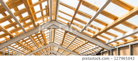 Construction of a large wooden roof 127965842