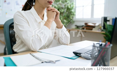 A business person nodding while looking at a contract 127966037