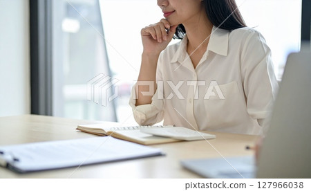 A business person nodding while looking at a contract 127966038