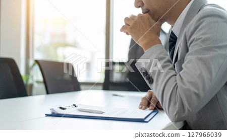 A business person nodding while looking at a contract 127966039