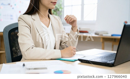 A business person nodding while looking at a contract 127966040
