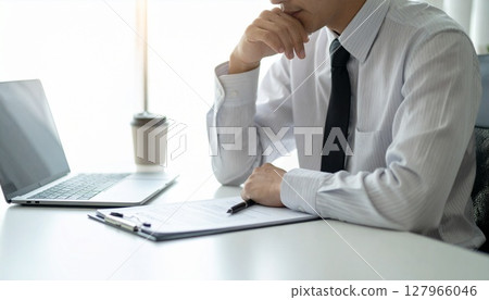 A business person nodding while looking at a contract 127966046