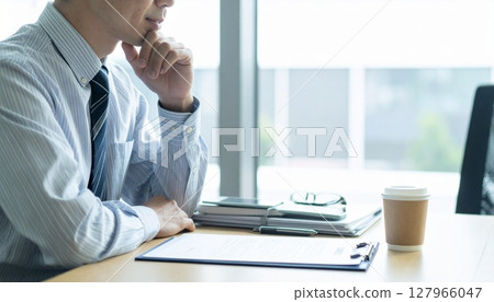 A business person nodding while looking at a contract 127966047