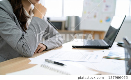 A business person nodding while looking at a contract 127966053