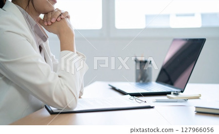 A business person nodding while looking at a contract 127966056