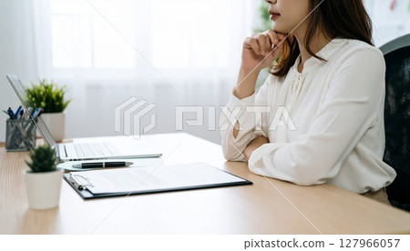 A business person nodding while looking at a contract 127966057