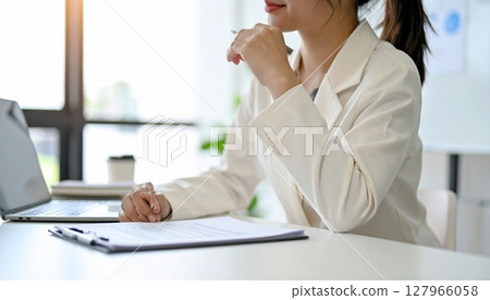 A business person nodding while looking at a contract 127966058