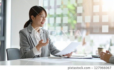A business person nodding while looking at a contract 127966067