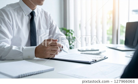A business person nodding while looking at a contract 127966068