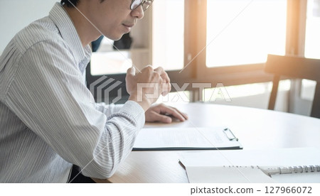 A business person nodding while looking at a contract 127966072
