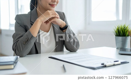 A business person nodding while looking at a contract 127966075