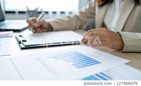 A business person nodding while looking at a contract 127966076