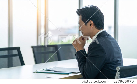 A business person nodding while looking at a contract 127966079