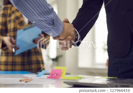 Business handshake of two male businessman after successful office meeting Business handshake of two male businessman after successful office meeting 127966459