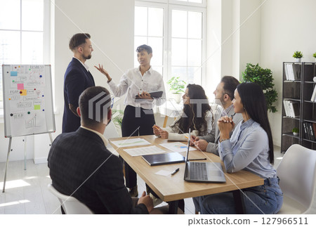 Business people sitting in modern office with colleagues on work conference. Teamwork concept Business people sitting in modern office with colleagues on work conference. Teamwork concept 127966511