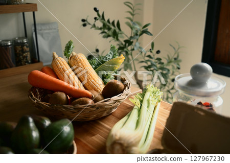 Basket of fresh vegetables on kitchen counter ready for cooking or healthy meal prep 127967230