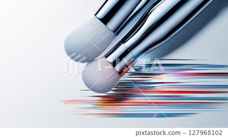 Close-up of silver makeup brushes with colorful strokes on white background 127968102