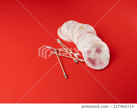 Dirty Cotton Pads and Swabs, Makeup Removal, Used Cotton Disks after Makeup Cleansing Dirty Cotton Pads and Swabs, Makeup Removal, Used Cotton Disks after Makeup Cleansing 127968314