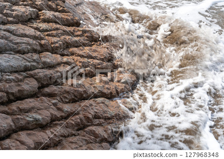 Layered rocks, flysch texture background. Sedimentary rock, striations stone pattern Layered rocks, flysch texture background. Sedimentary rock, striations stone pattern 127968348