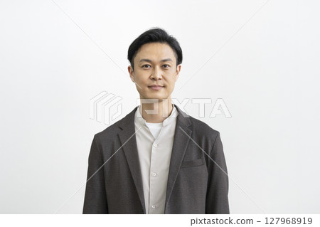 Middle-aged man smiling at the camera, white background, portrait 127968919