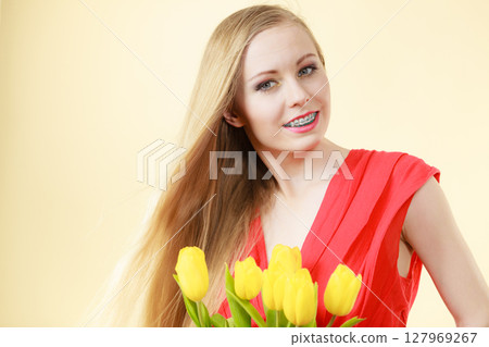 Pretty woman with yellow tulips bunch Pretty woman with yellow tulips bunch 127969267