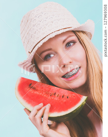 Happy woman holding watermelon 127969308