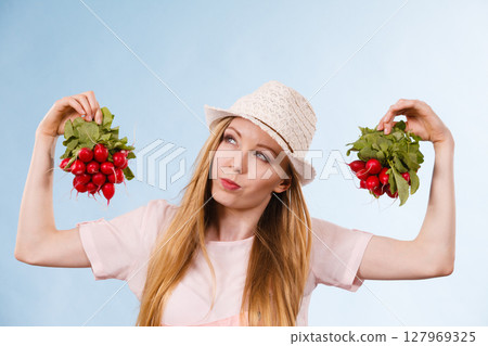 Happy woman holding radish Happy woman holding radish 127969325